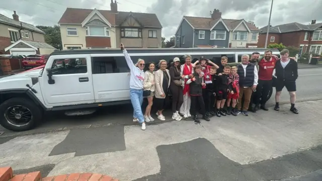 Group of 15 Liverpool fans setting off in a limo for the parade