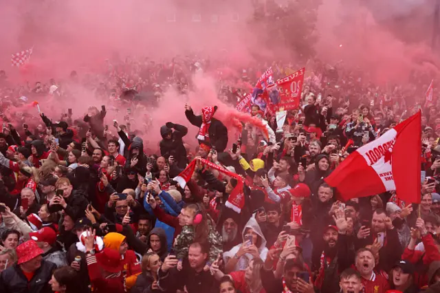 Supporters of Liverpool light smoke flares during the Liverpool Trophy Parade