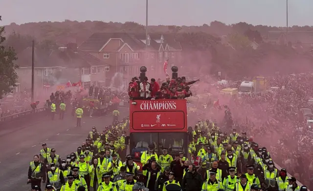 Liverpool parade bus surrounded by police as it heads over flyover on Queens Drive