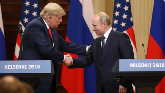 Donald Trump and Vladimir Putin shaking hands.