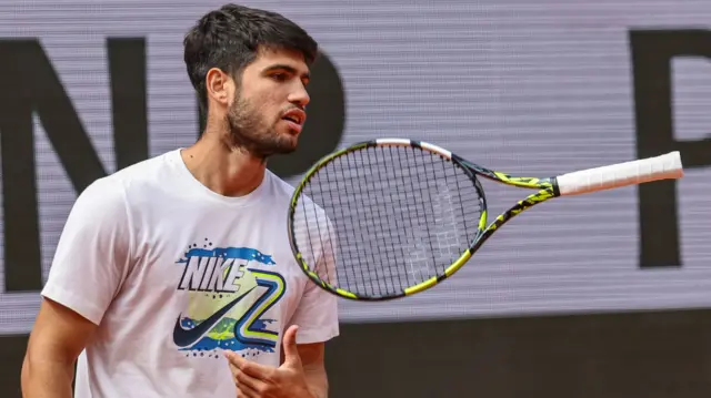 Carlos Alcaraz throws his racquet