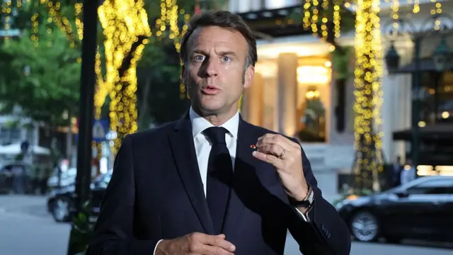 Emmanuel Macron wearing a navy suit