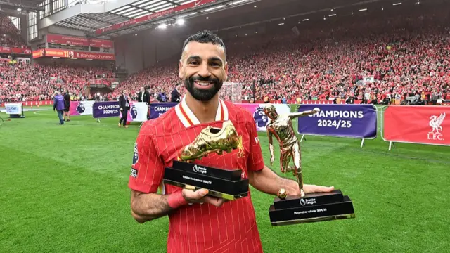 Mohamed Salah celebrates with his two awards