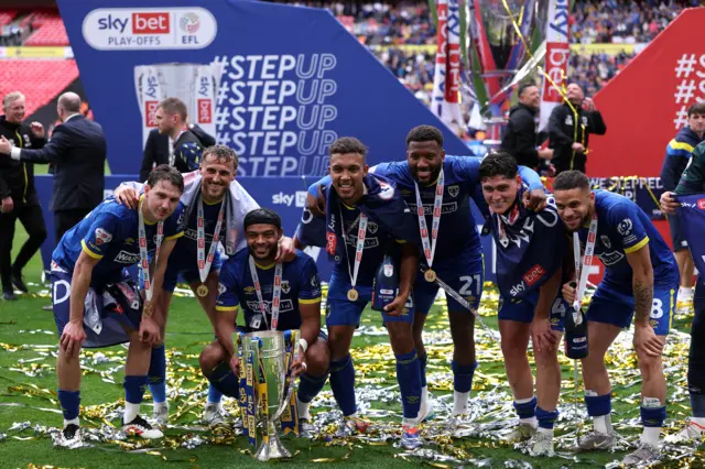 Wimbledon's Joe Lewis celebrates along with his team-mates