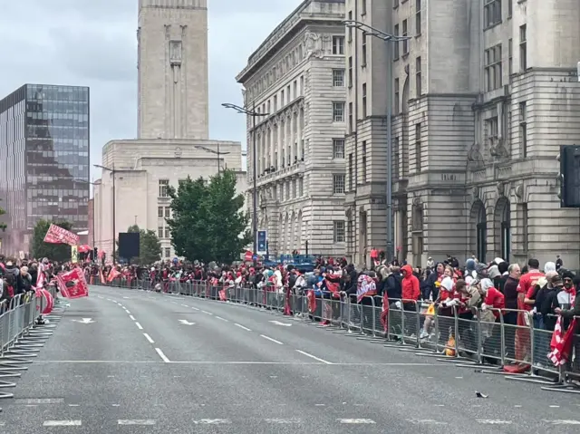 Lines of people at The Strand in Liverpool