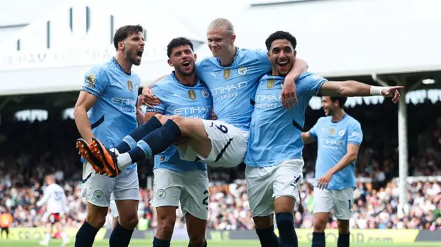 Man City players celebrate against Fulham