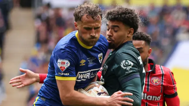Wimbledon defender Joe Lewis in action against Walsall