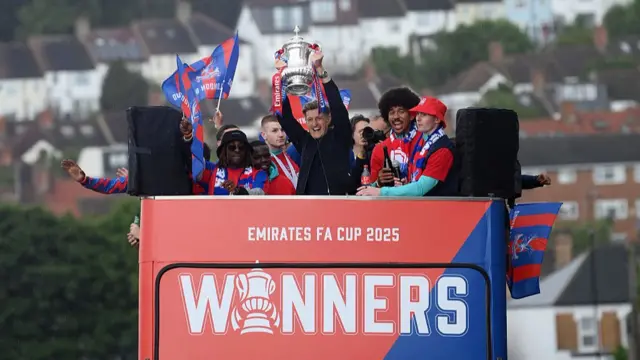 A man holding a trophy above his head