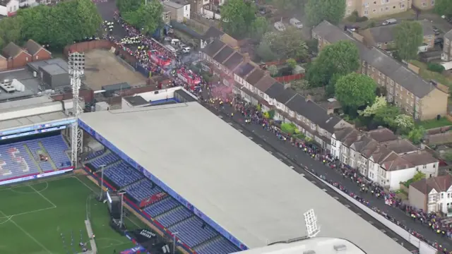 Buses shown in an aerial view alongside the football stadium