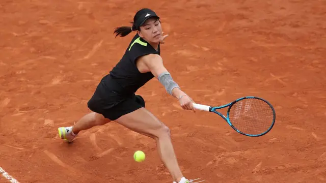 Wang Xinyu stretches for a backhand