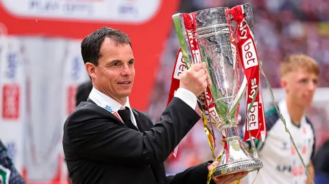 Regis Le Bris with Championship play-off trophy