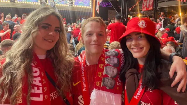 Three people in Liverpool colours