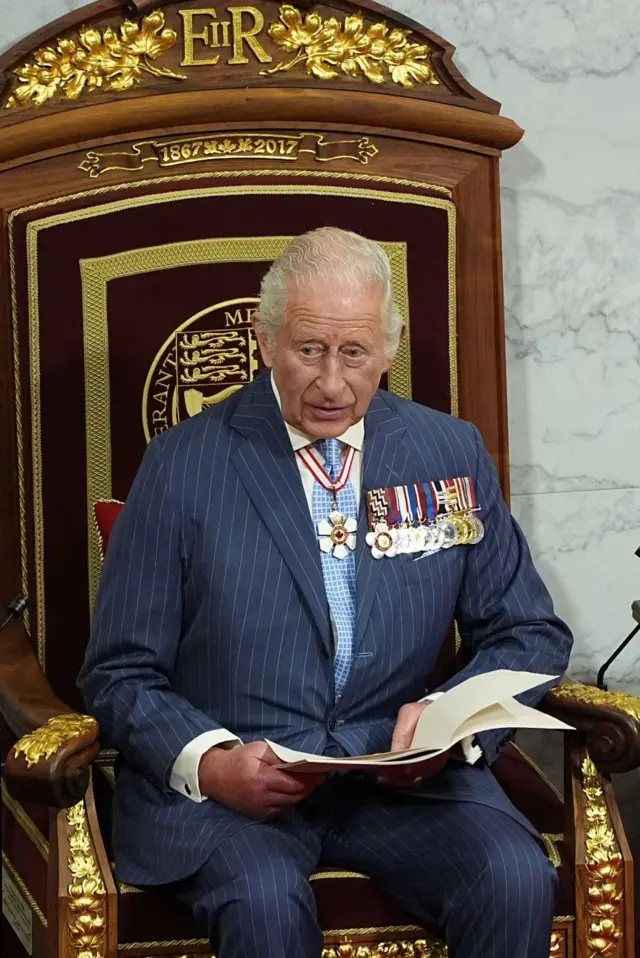 The King speaking on the throne