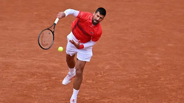 Novak Djokovic serves