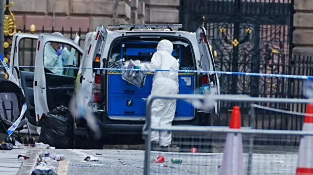 orensic officers at the scene in Water Street near the Liver Building in Liverpool after a 53-year-old white British man was arrested when a car ploughed into a crowd of people during Liverpool FC's Premier League victory parade. Picture date: Tuesday May 27, 2025.