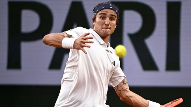 Mattia Bellucci plays a forehand return