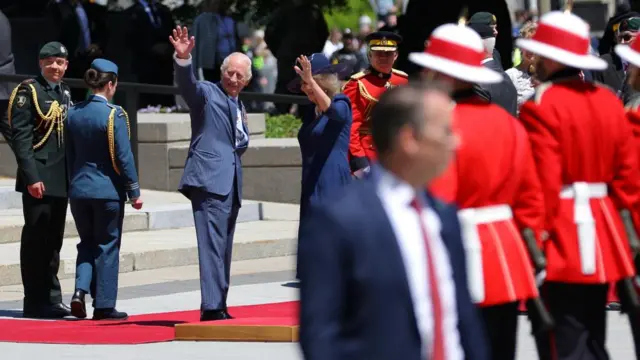 The royal couple waves to a crowd