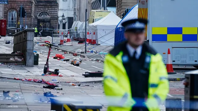 Police tents surrounded by debris at the scene in Water Street near the Liver Building in Liverpool city centre after a 53-year-old white British man was arrested when a car ploughed into a crowd of people during Liverpool FC's Premier League victory parade