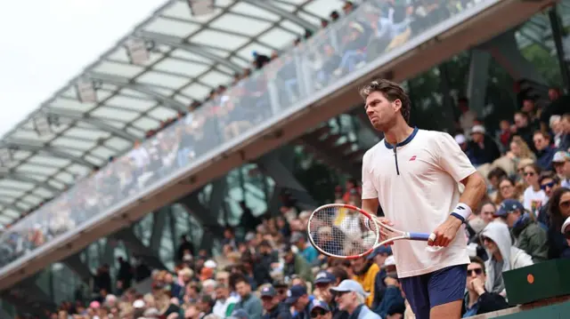 Cameron Norrie walks off court