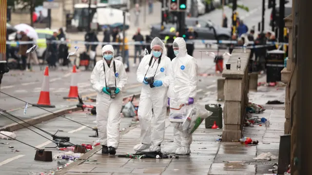 Forensics officers at the scene where a car collided with people during the Liverpool FC trophy parade in Liverpool city centre, Britain, 27 May 2025. A 53-year-old British man has been detained after the collision with a number of pedestrians during Liverpool FC's victory parade, Merseyside Police said.