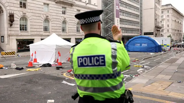 Policeman outside where collision took place