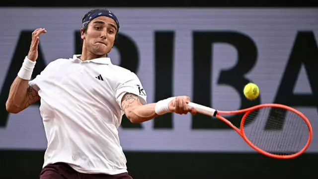 Mattia Bellucci plays a forehand return