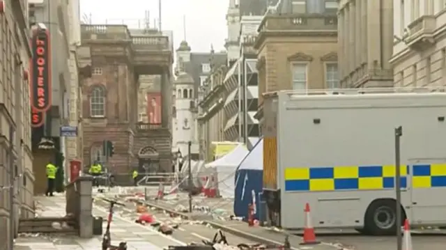 Water Street, Liverpool, littered with rubbish and police vehicle in front of police scene