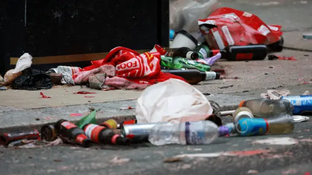 A Liverpool football club scarf lies on the ground at the scene in the aftermath of an incident where a car plowed into a crowd of Liverpool fans during a parade celebrating their side's Premier League soccer title, in central Liverpool, Britain, May 27, 2025.