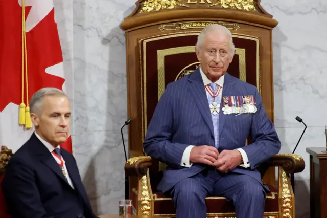 King Charles sat on the throne next to Mark Carney