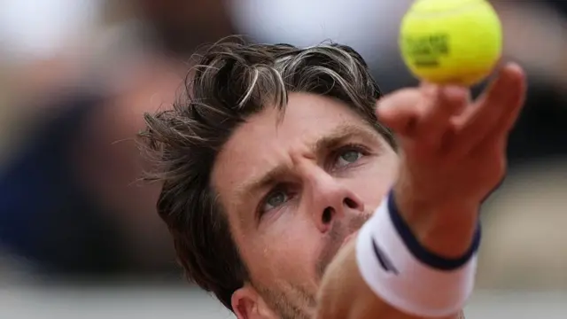 Cameron Norrie serves
