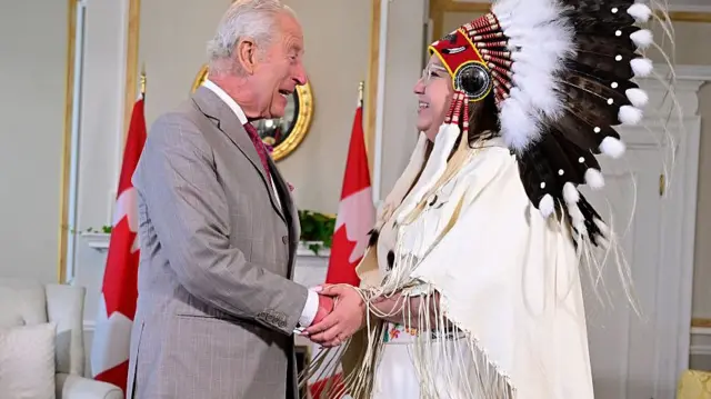 King Charles shakes hands with Assembly of First Nations National Chief Cindy Woodhouse.