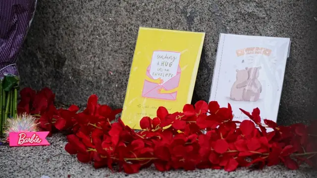 Two cards and flowers on the street