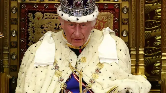 King Charles sits on the throne in London