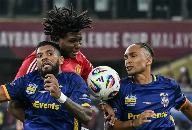 Manchester United's Patrick Dorgu leaps for a header.