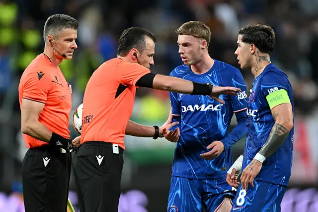 Referee Irfan Peljto speaks to Cole Palmer and Enzo Fernandez of Chelsea as Assistant Referee Davor Beljo looks on