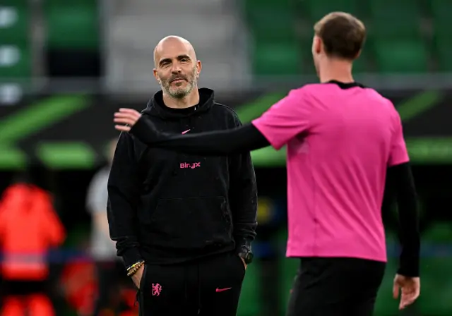 Enzo Maresca, Manager of Chelsea, speaks to Cole Palmer