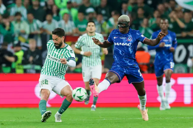 Isco of Real Betis Balompie and Moises Caicedo of Chelsea FC battle for the ball