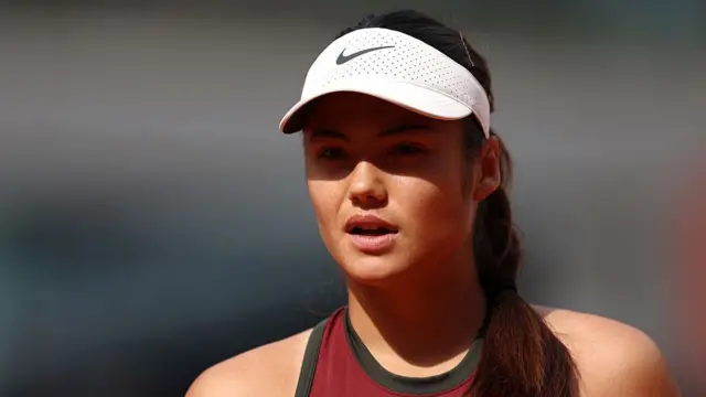 Emma Raducanu looks on