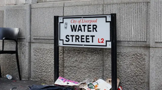 Debris beneath the street sign for Water Street near the Liver Building in Liverpool city centre