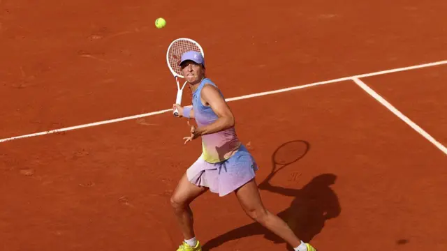Iga Swiatek of Poland plays a forehand