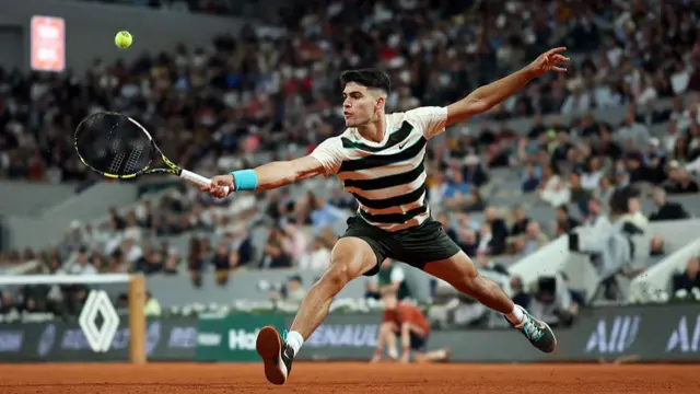 Carlos Alcaraz plays a shot