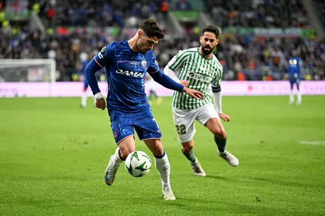 Pedro Neto of Chelsea controls the ball under pressure from Isco