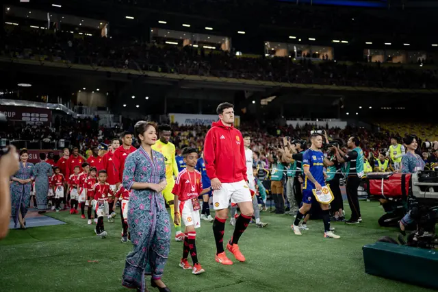 Harry Maguire leads out hthe Manchester United team for the match against ASEAN All-Stars