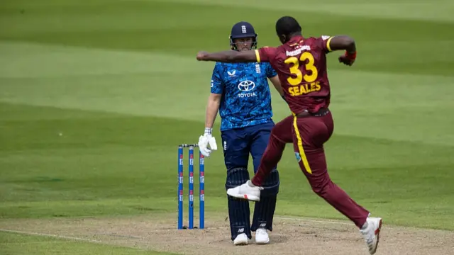 Jayden Seales of West Indies celebrates after taking the wicket of Joe Root