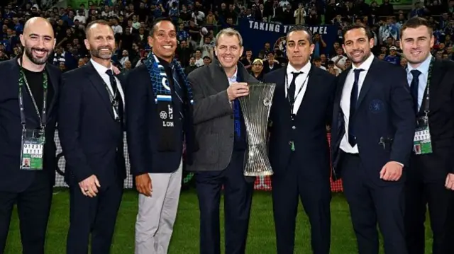 Todd Boehly holds the Conference League trophy after Chelsea win the 2025 final