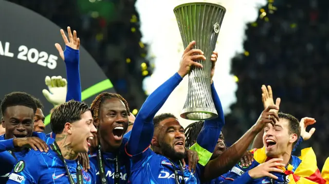Reece James lifts the Conference League trophy while his Chelsea team-mates celebrate