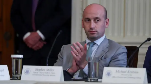 Stephen Miller is seen applauding at an event in the White House