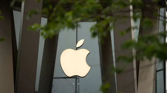 Apple logo on glass and wood building