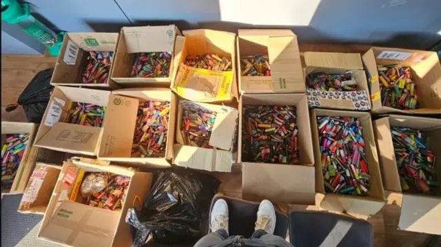 Boxes on a shop floor filled to the brim with vapes
