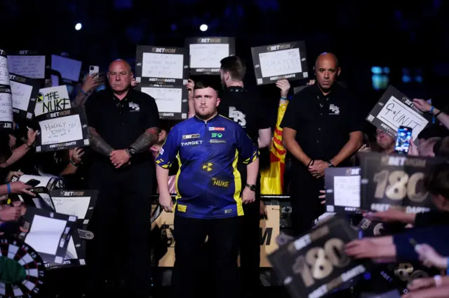 Luke Littler prepares to walk on